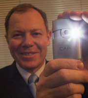 CAP-XX CEO with a supercapacitor in a flash camera 